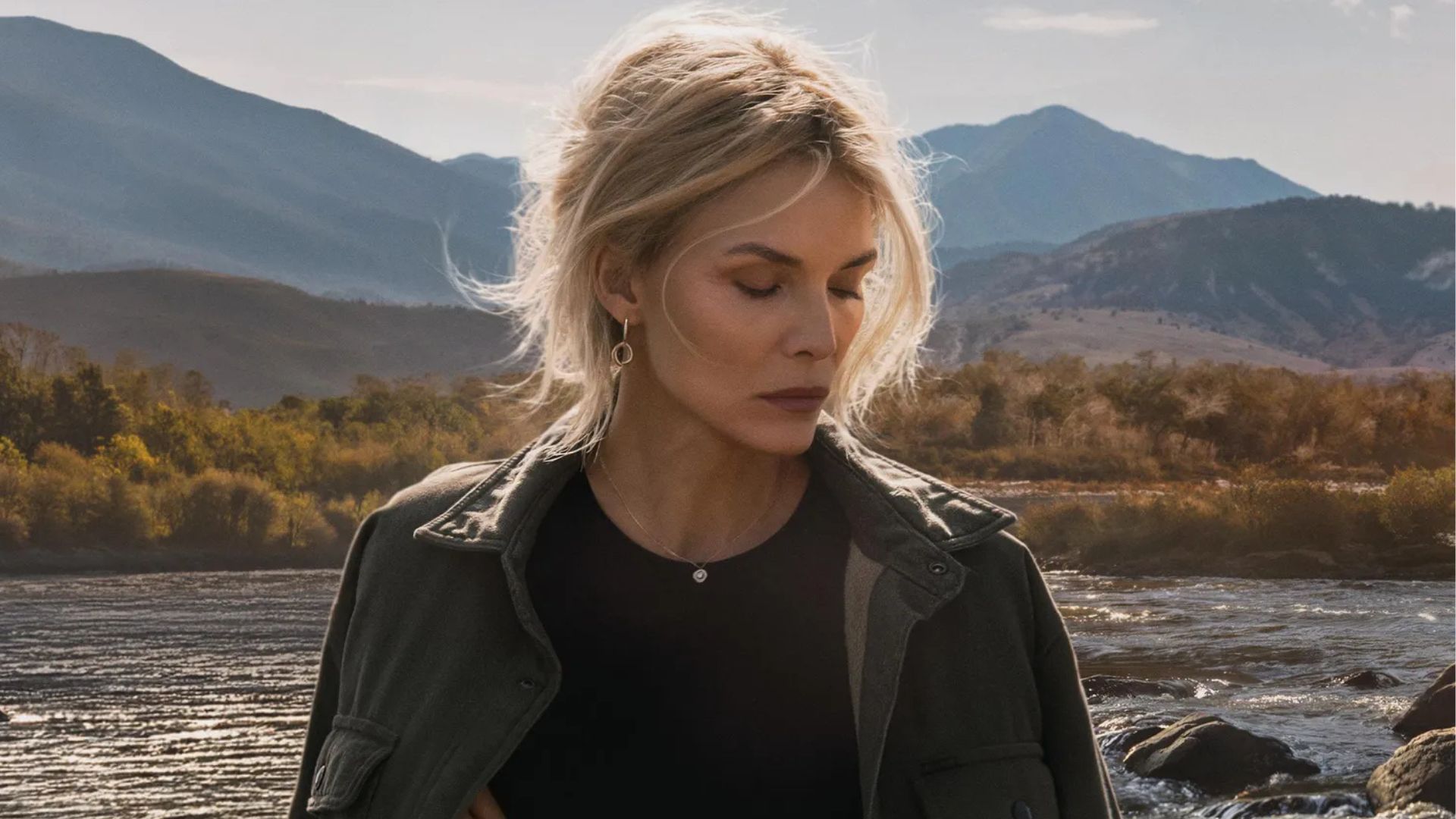 Michelle Pfeiffer stands in front of a Montana mountain range