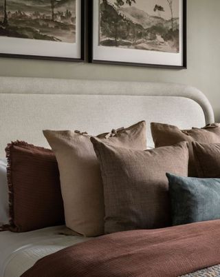 earth palette decorative pillows styled on bed
