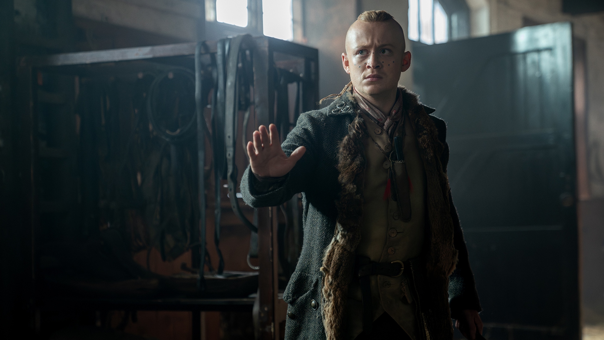 Young Ian reaches out his hand in Outlander season 7