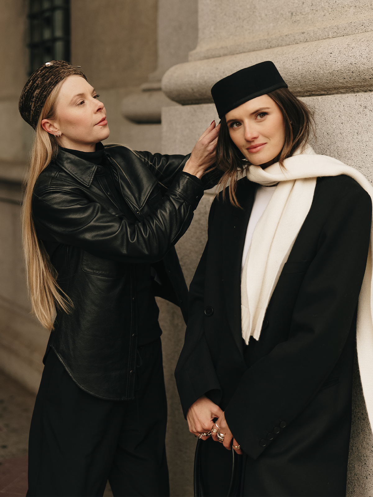 Photo of Gigi Burris and Coco Schiffer wearing pillbox hats.