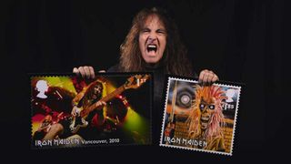 Steve Harris holding mock-ups of the Iron Maiden stamps