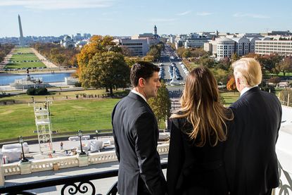 Donald Trump looks out over Washington with wife Melania and Paul Ryan