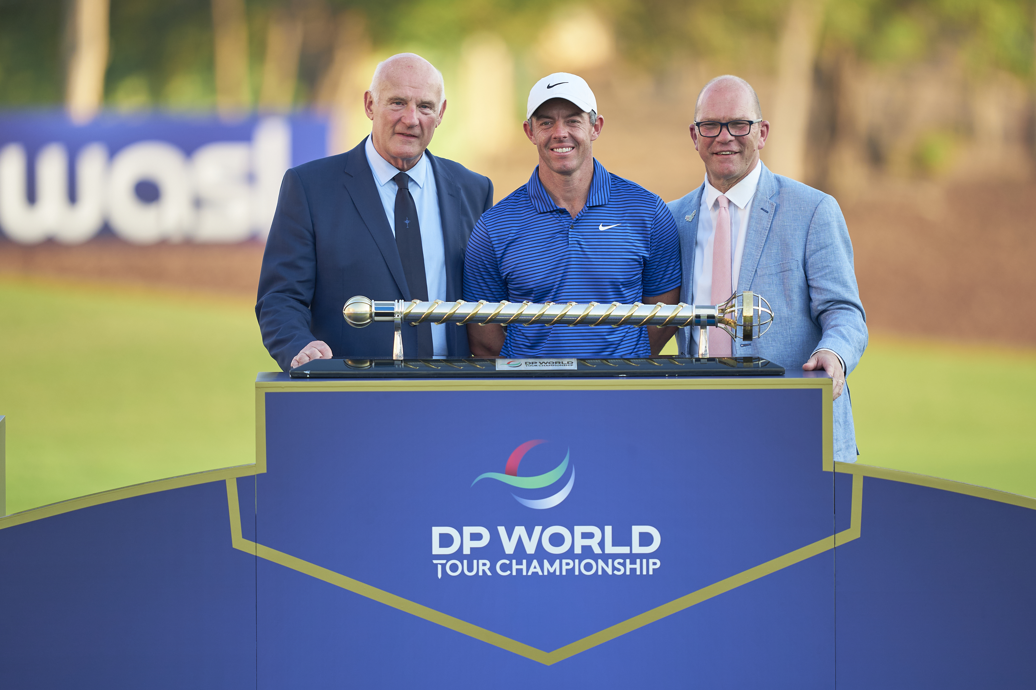 (L to R) Eric Nicoli, Rory McIlroy and Guy Kinnings pose with the DP World Tour Championship trophy
