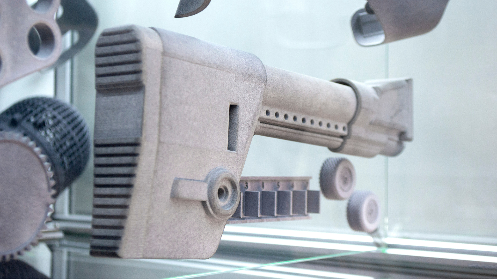 3D-printed gun parts on a display shelf