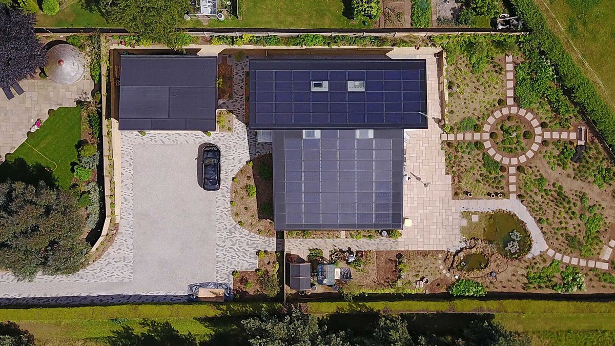 aerial view of a Passivhaus project with a roof covered in solar PV tiles