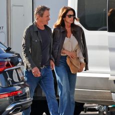 An image of Cindy Crawford wearing jeans and a leather jacket. 