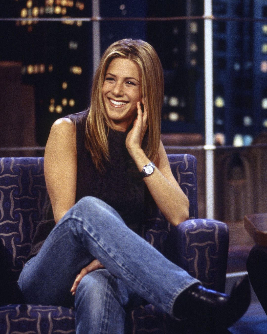 Jennifer Aniston wears stove pipe jeans with boots.