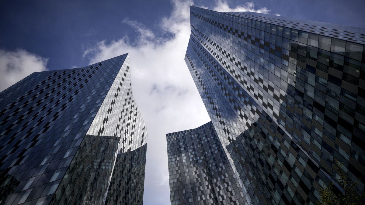 Three towers in Manchester&amp;#039;s Deansgate Square against a clear blue, slightly cloudy sky 