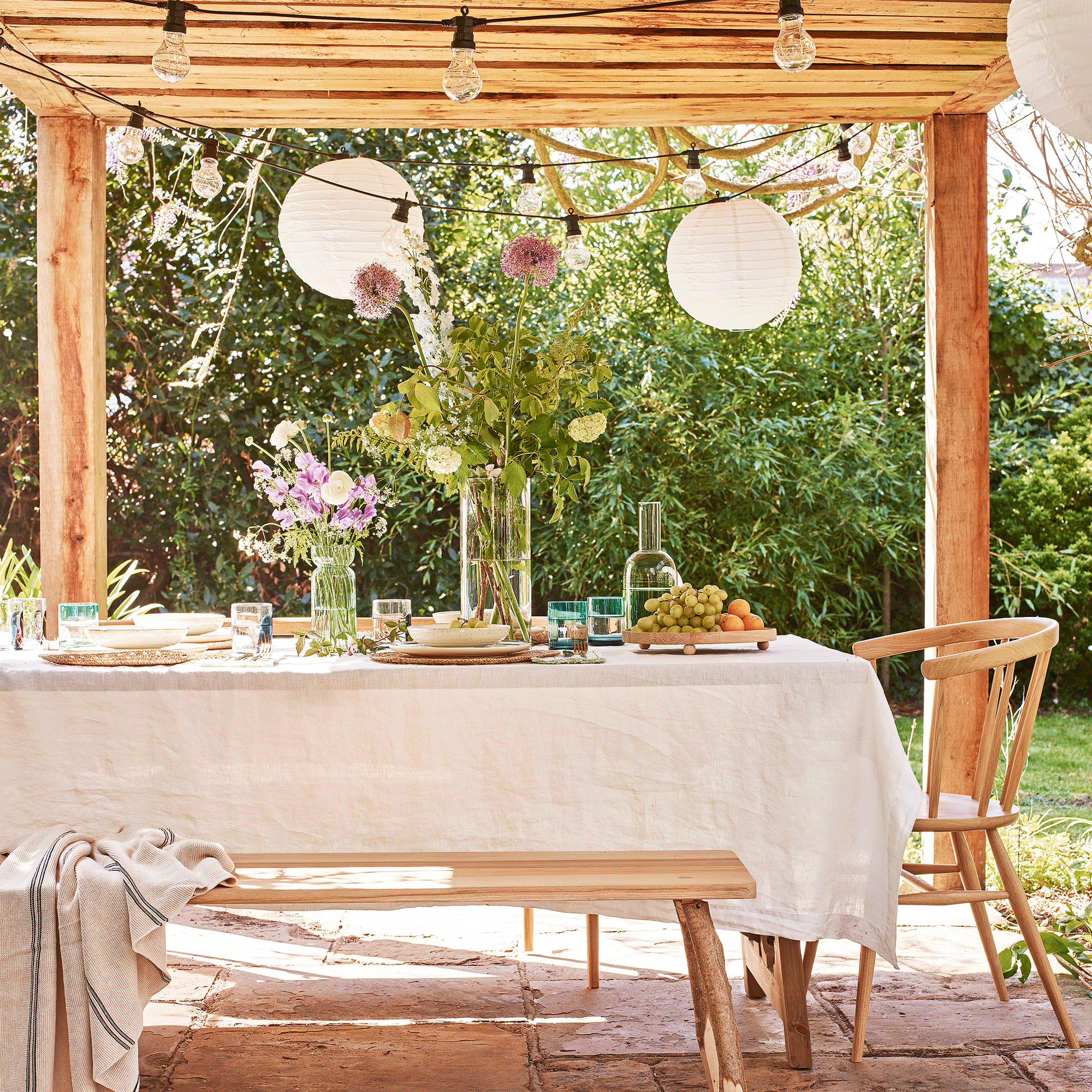 Wooden pergola with table with linen cloth
