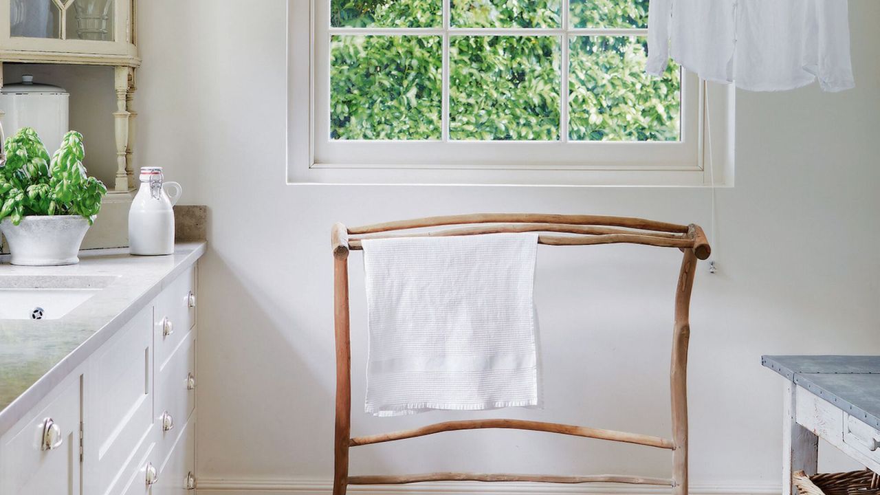 laundry room with wooden drying rack and shirt