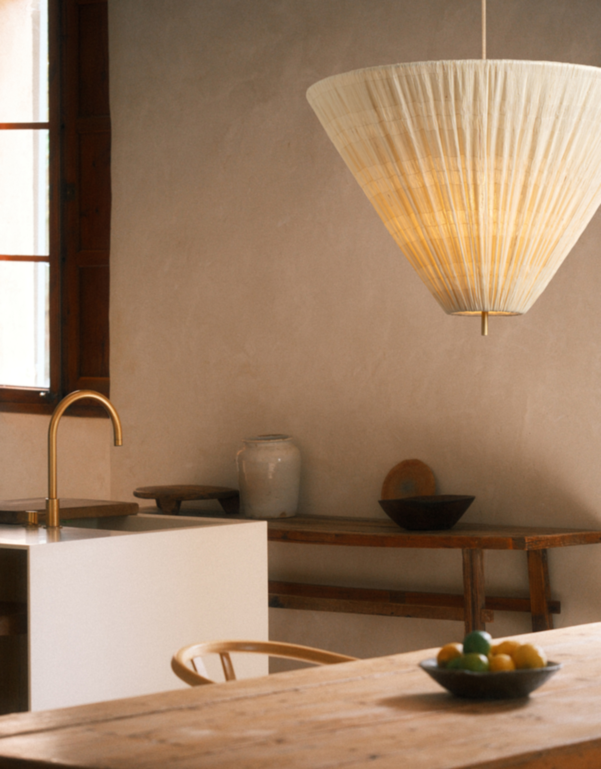A large pendant lamp over a wood dining table with a ruched fabric shade from lights&amp;amp;lamps