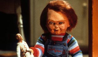 Child's Play Chucky holding a voodoo doll