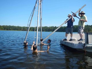 Collecting sediment cores from White Pond in 2016.