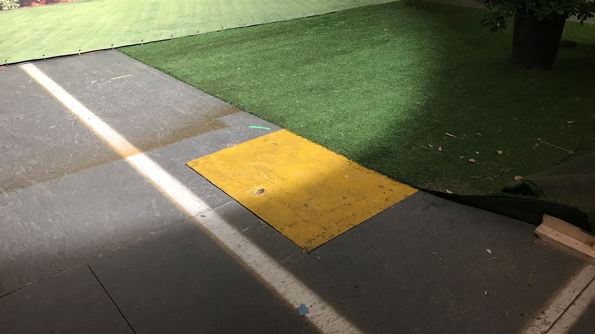 a rectangle of wood on a grey industrial floor