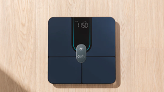 Eufy P2 Pro smart scales on a wooden floor