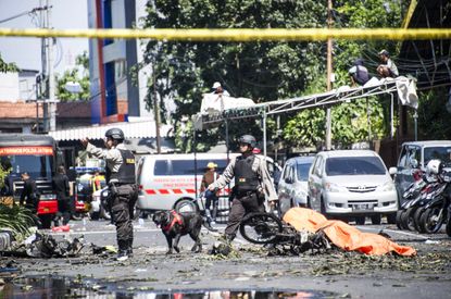 K9 police examine a site following attacks outside the Surabaya Centre Pentecostal Church (Surabaya Gereja Pantekosta Pusat) in Surabaya, East Java on May 13, 2018. 