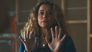 Tatiana Maslany standing with her hands up in Maximum Plesure Garanteed. 