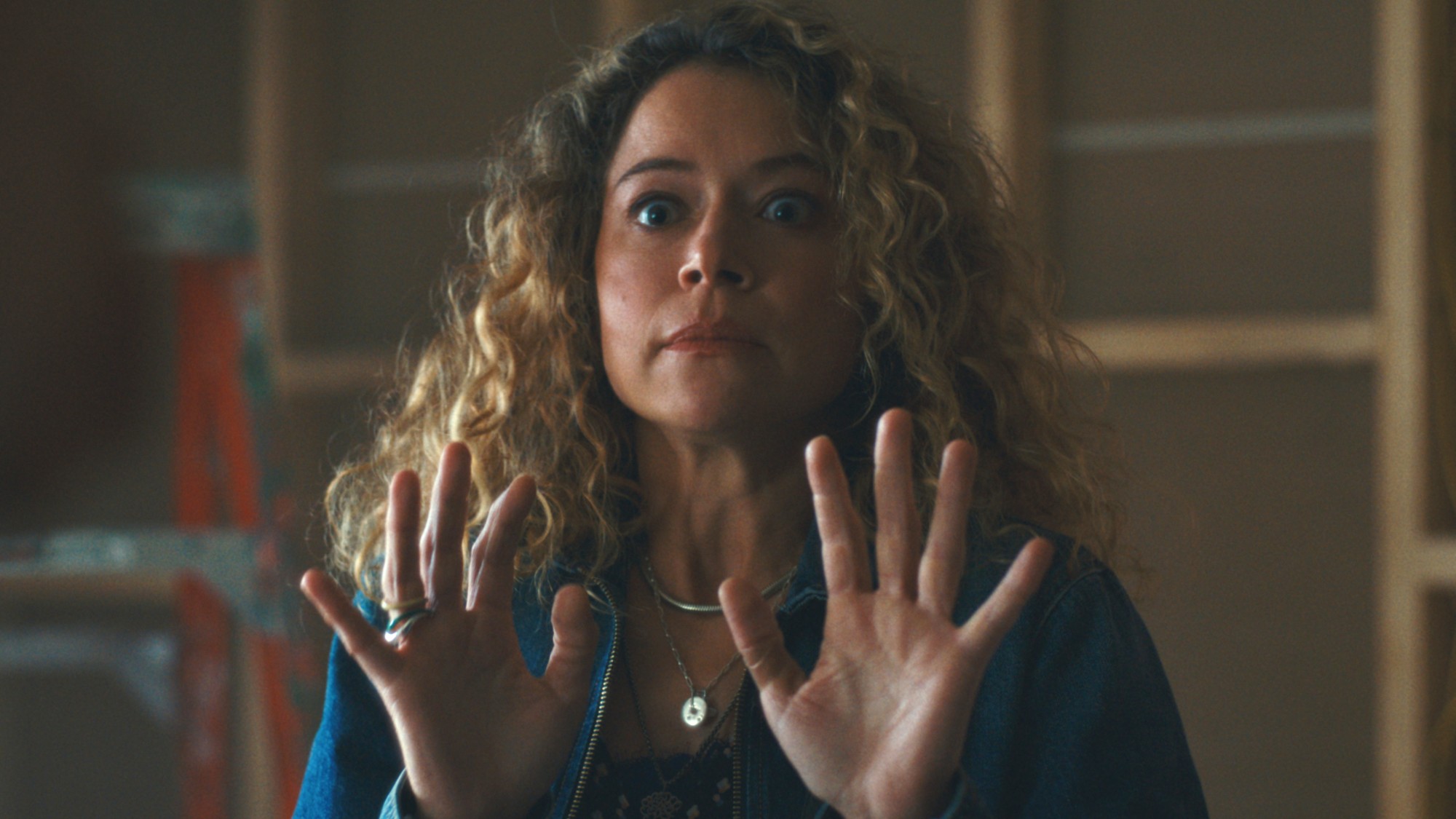 Tatiana Maslany standing with her hands up in Maximum Plesure Garanteed. 