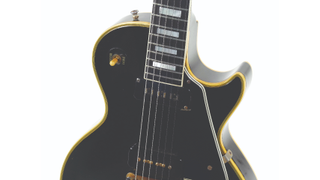 Close-up of a Gibson’s “Black Beauty” Les Paul Custom electric guitar from the front