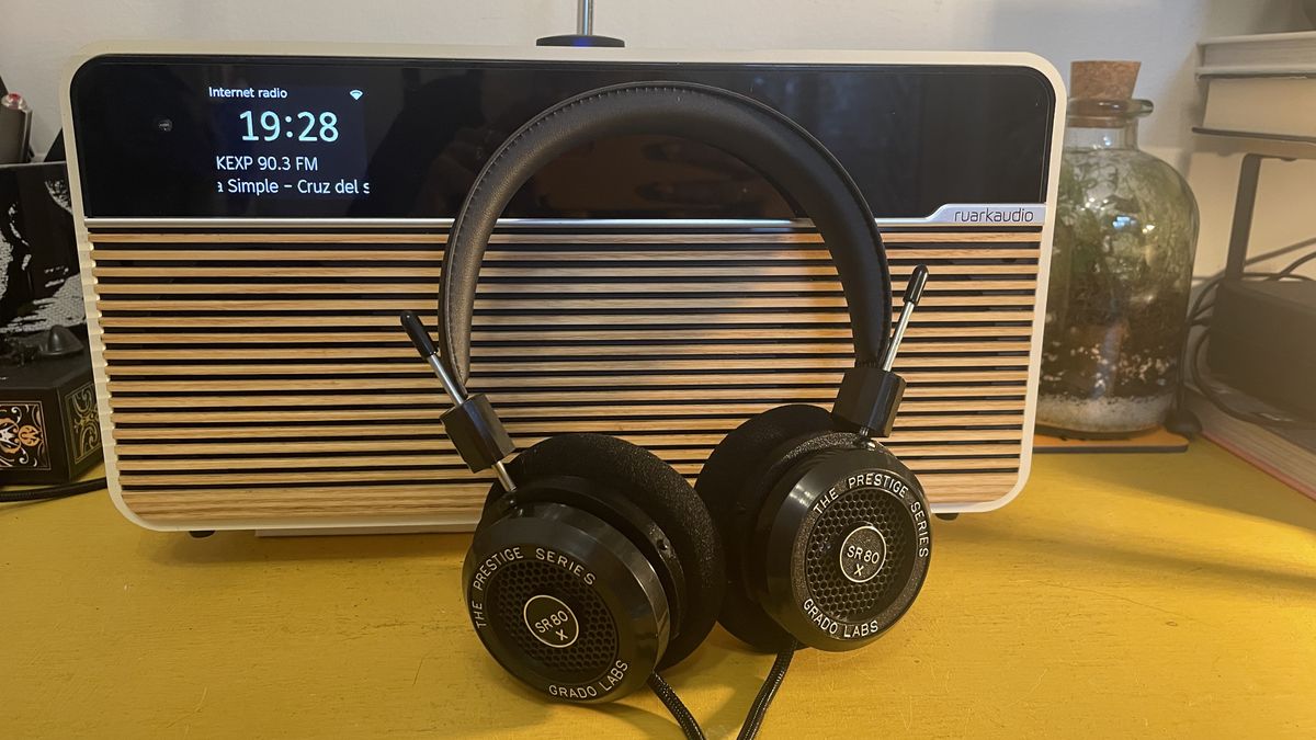 Grado SR80x headphones placed on Ruark R2 Mk4 radio on yellow table