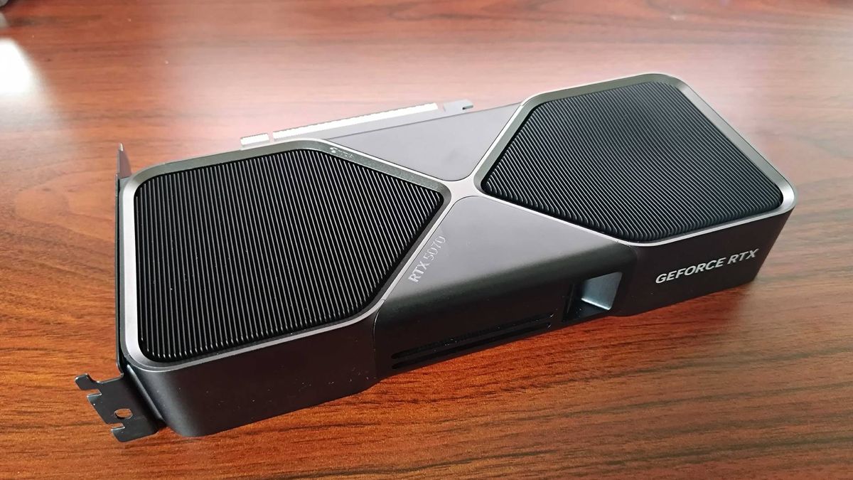 RTX 5070 Founders Edition sitting on woodgrain desk