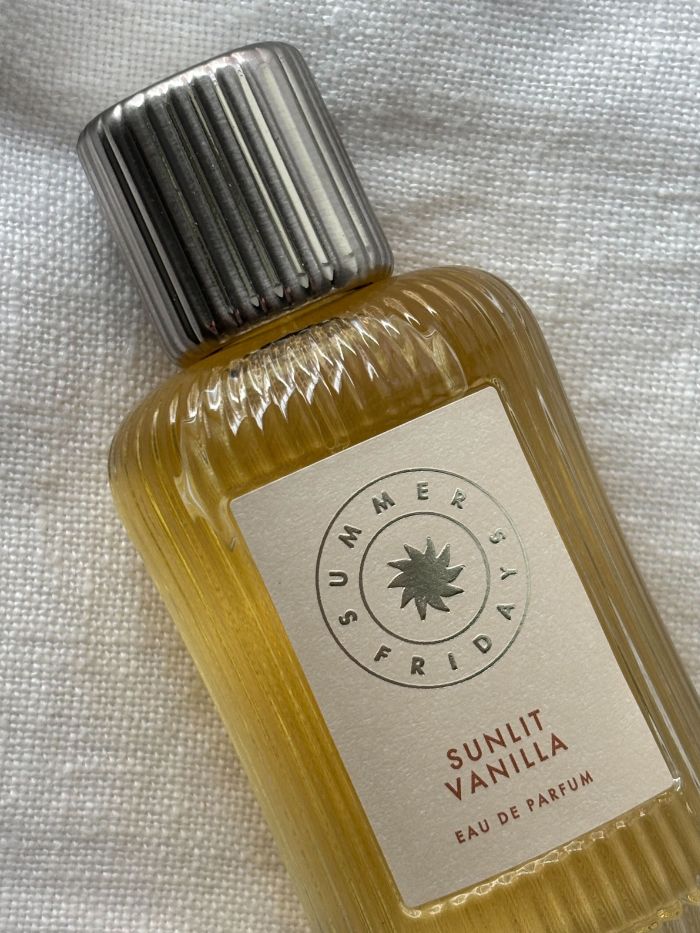 The Summer Fridays Sunlit Vanilla perfume on a white linen background