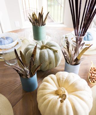 Thanksgiving feather centerpiece decor idea with blue and green matte finish pumpkins and vases
