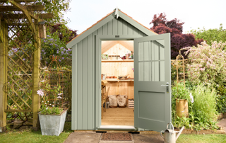 Green shed in a garden with the door open