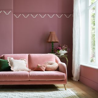 Gosh Golly by Earthborn used in a living room with a pink velvet sofa