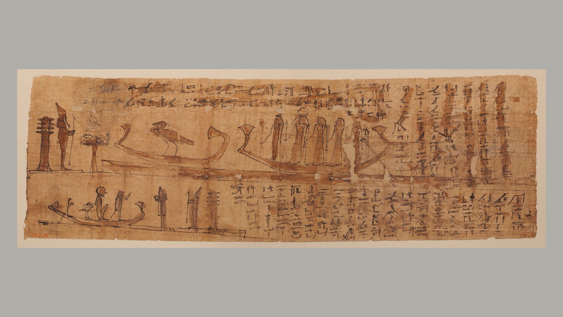Book of the Dead Papyrus with Chapters 100 and 129. On the top are the text and vignette for spell 129. At the left of the vignette is the god Osiris holding a was-scepter; behind him stands a large djed-pillar. In front of the god is an offering table with food topped by a large lotus flower. Farther to the right is a long and low rectangle, which is presumably depicting water; on top of it are two boats. In the left one is the phoenix, while five deities stand in the right one. The lower part of the papyrus features spell 100. This time, Osiris is depicted on the right side, again with a djed-pillar behind him. In front of the god is the emblem for the east, and to the left of this is a boat being punted by a woman (the deceased) with a long oar. Behind her sits the sun god and then the phoenix.