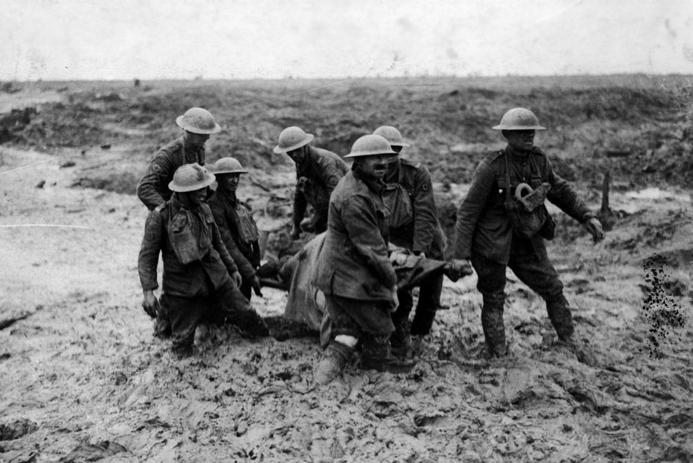 A stretcher-bearing party carrying a wounded soldier through the mud near Boesinghe during the battle of Passchendaele in Flanders. (Photo by John Warwick Brooke/Getty Images)