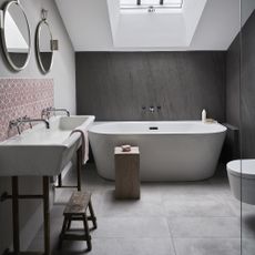 Grey modern bathroom with freestanding bath.