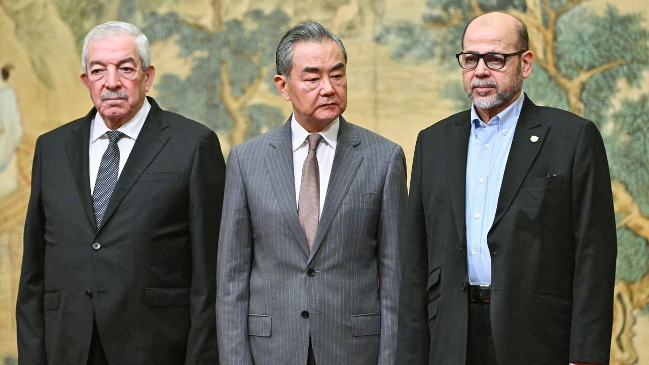 Mahmoud al-Aloul, Vice Chairman of the Central Committee of Palestinian organisation and political party Fatah, China&#039;s Foreign Minister Wang Yi, and Mussa Abu Marzuk, senior member of Hamas