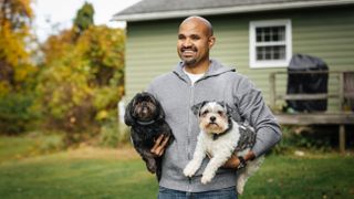 Man outside with his two dogs