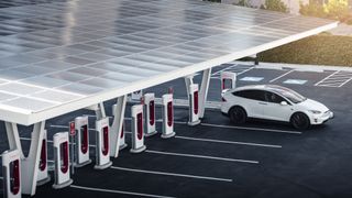 Looking down at a Tesla SuperCharger station with one Model X charging
