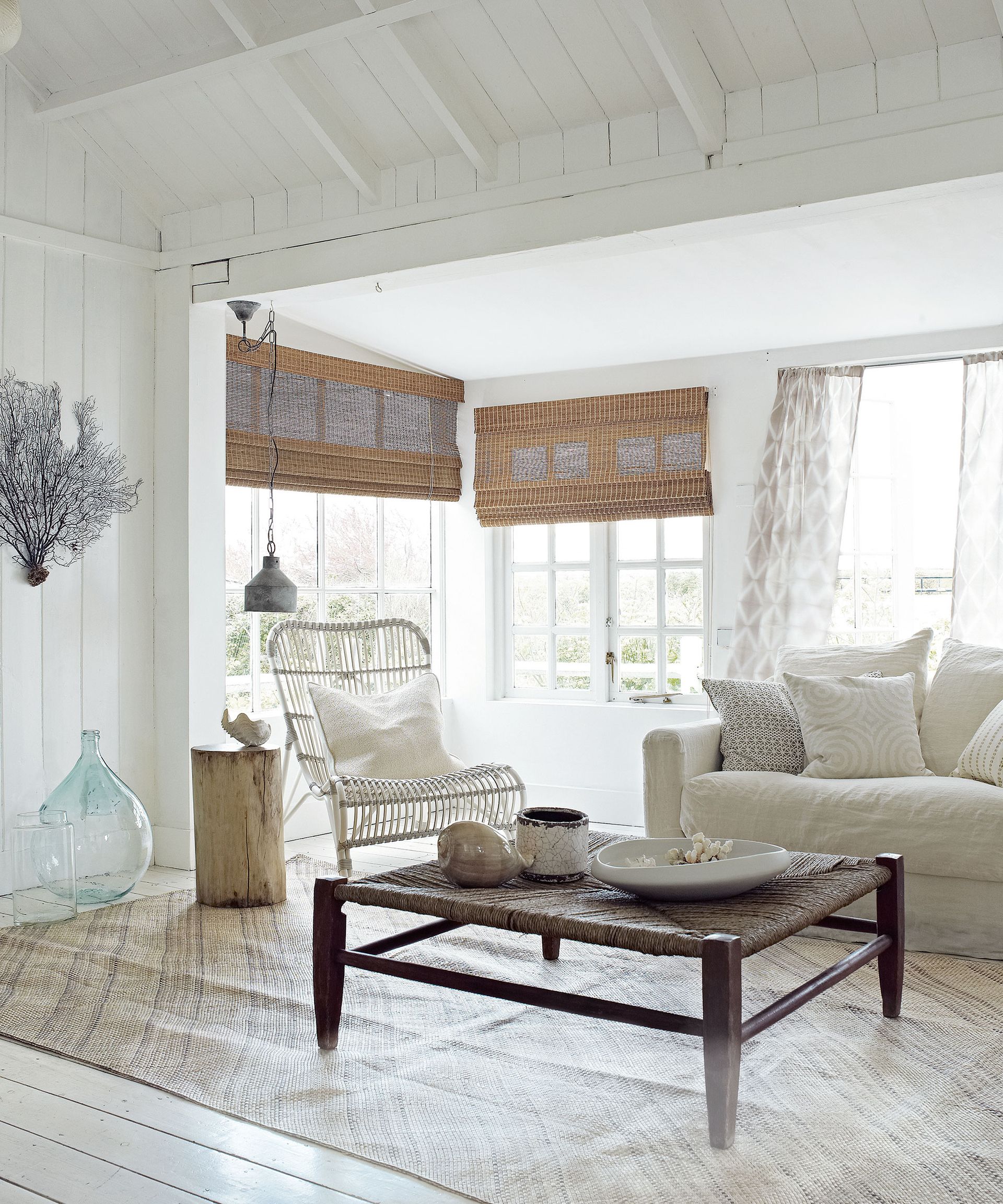 Coastal living room ideas with whitewashed walls and cane furniture
