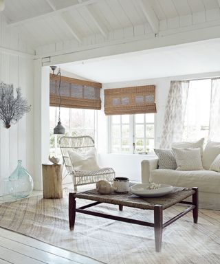 Coastal living room ideas with whitewashed walls and cane furniture