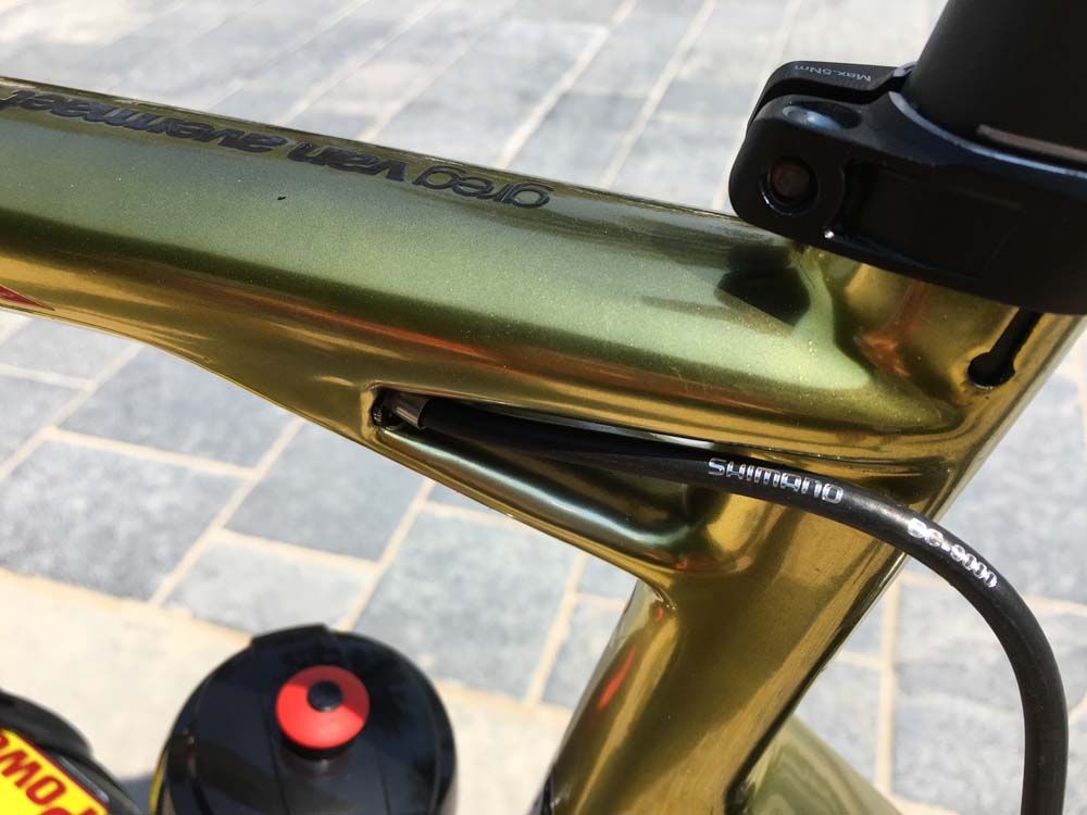 The rear brake cable passes through the gap in the top tube