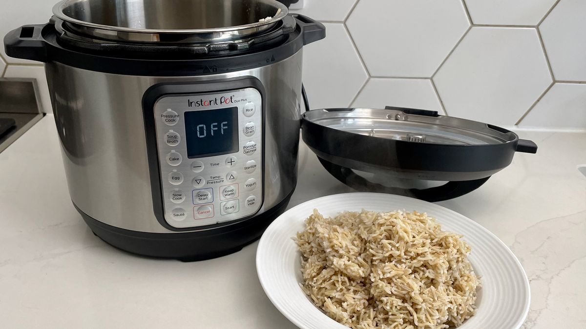 The Instant Pot Duo Plus alongside some brown rice that was prepared in the multi-cooker