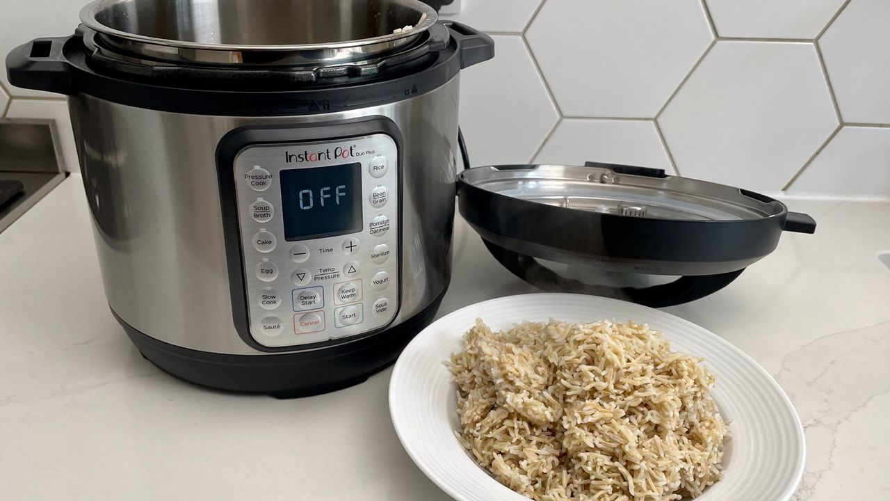 The Instant Pot Duo Plus alongside some brown rice that was prepared in the multi-cooker