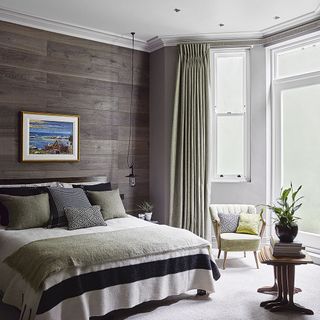 bedroom with wooden panels and photo frame