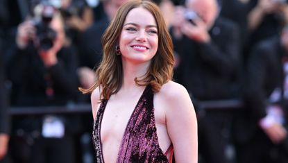 Emma Stone wears a plunge dress by Louis Vuitton on the Cannes 2024 red carpet