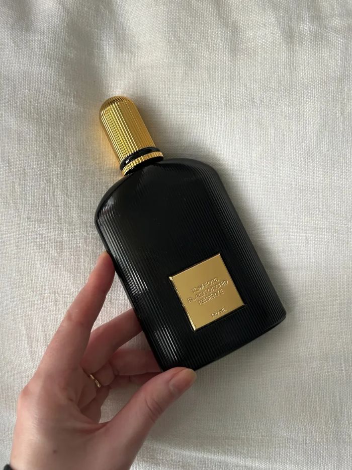 Tom Ford Black Orchid Reserve perfume on a cream linen background