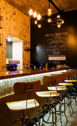 Mr Livanets restaurant in Moscow with leather sofas, industrial lighting and wall art