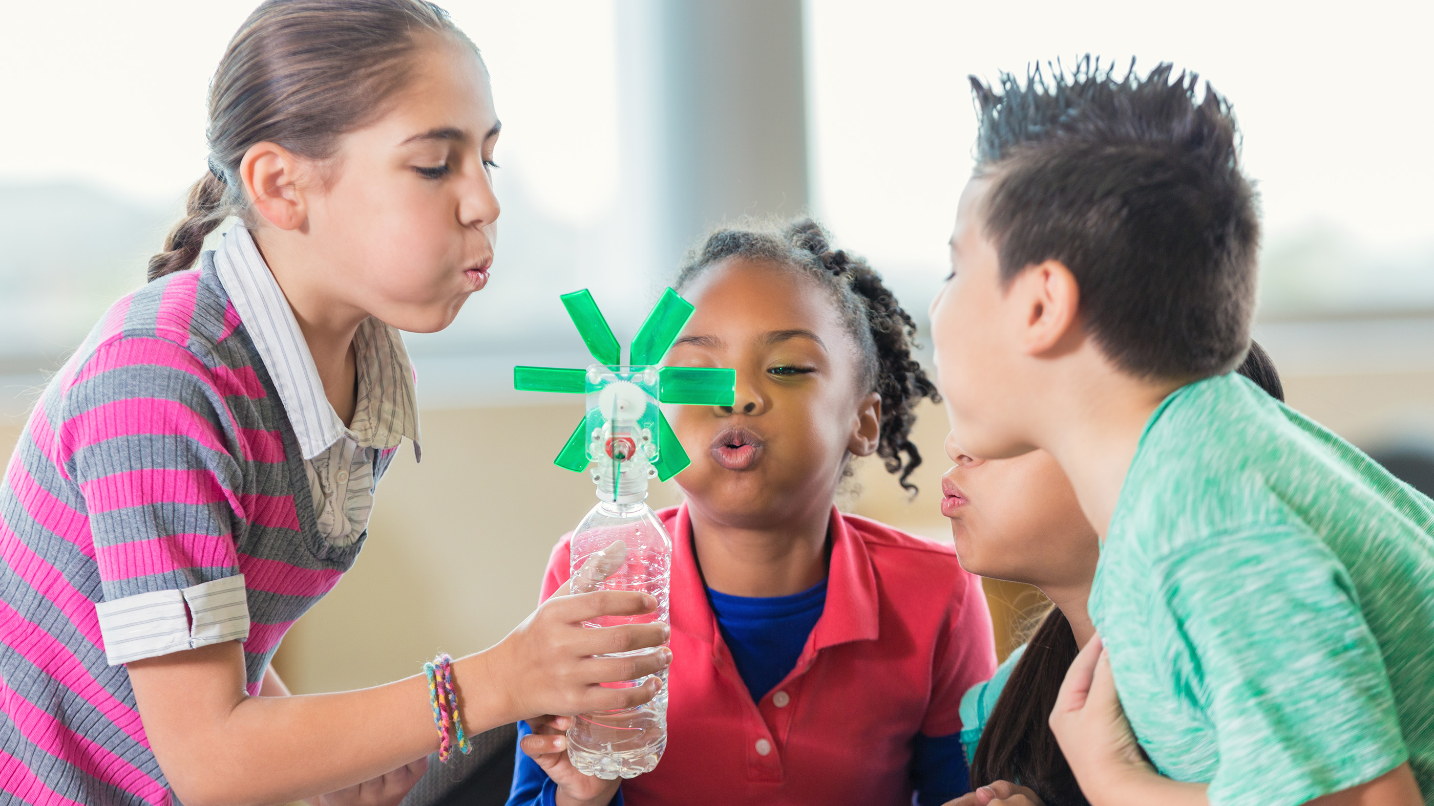 Elementary-age students study alternative energy using homemade windmills during public school science class.