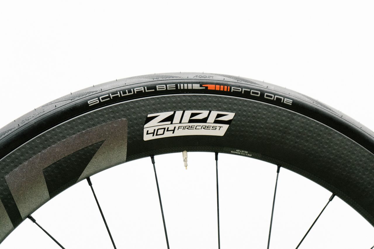 An aero road wheel stands against a white wall