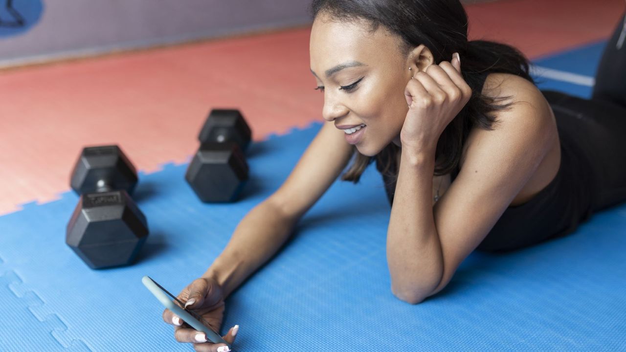 Woman checks phone while resting 