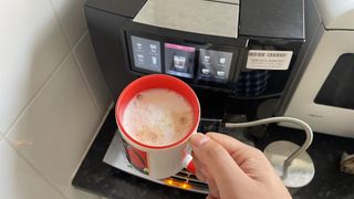 JURA GIGA 10 with flat white coffee in mug
