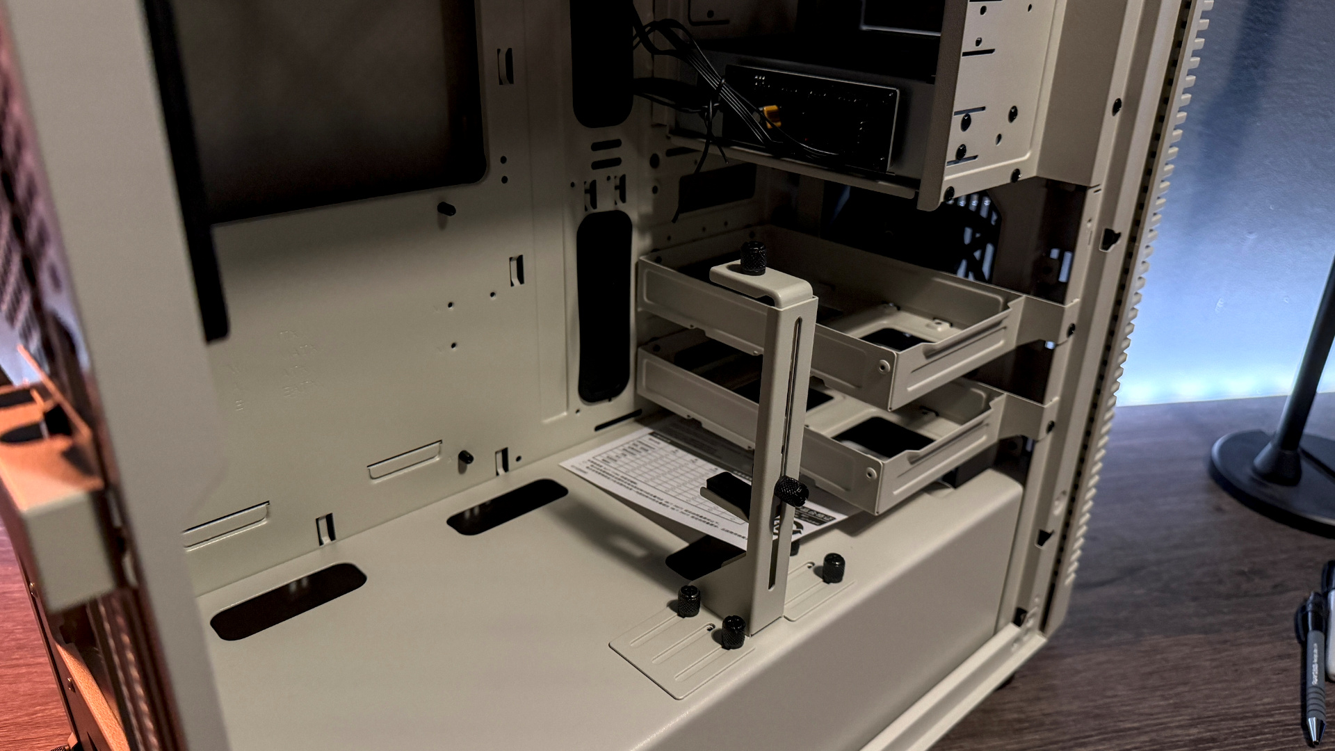 The retro-styled Silverstone FLP02 PC case as a PC is being built into it on a desk.