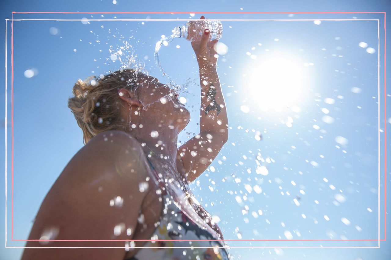 A woman pouring water on herself on a hot day